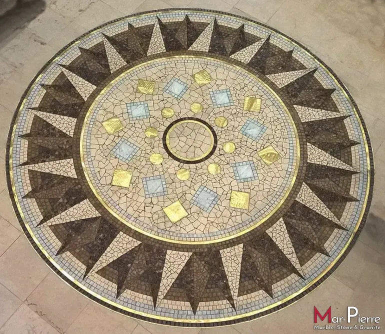 Artistic mosaic made of marble crema marfil, emperador dark, emperador light and brass inserts